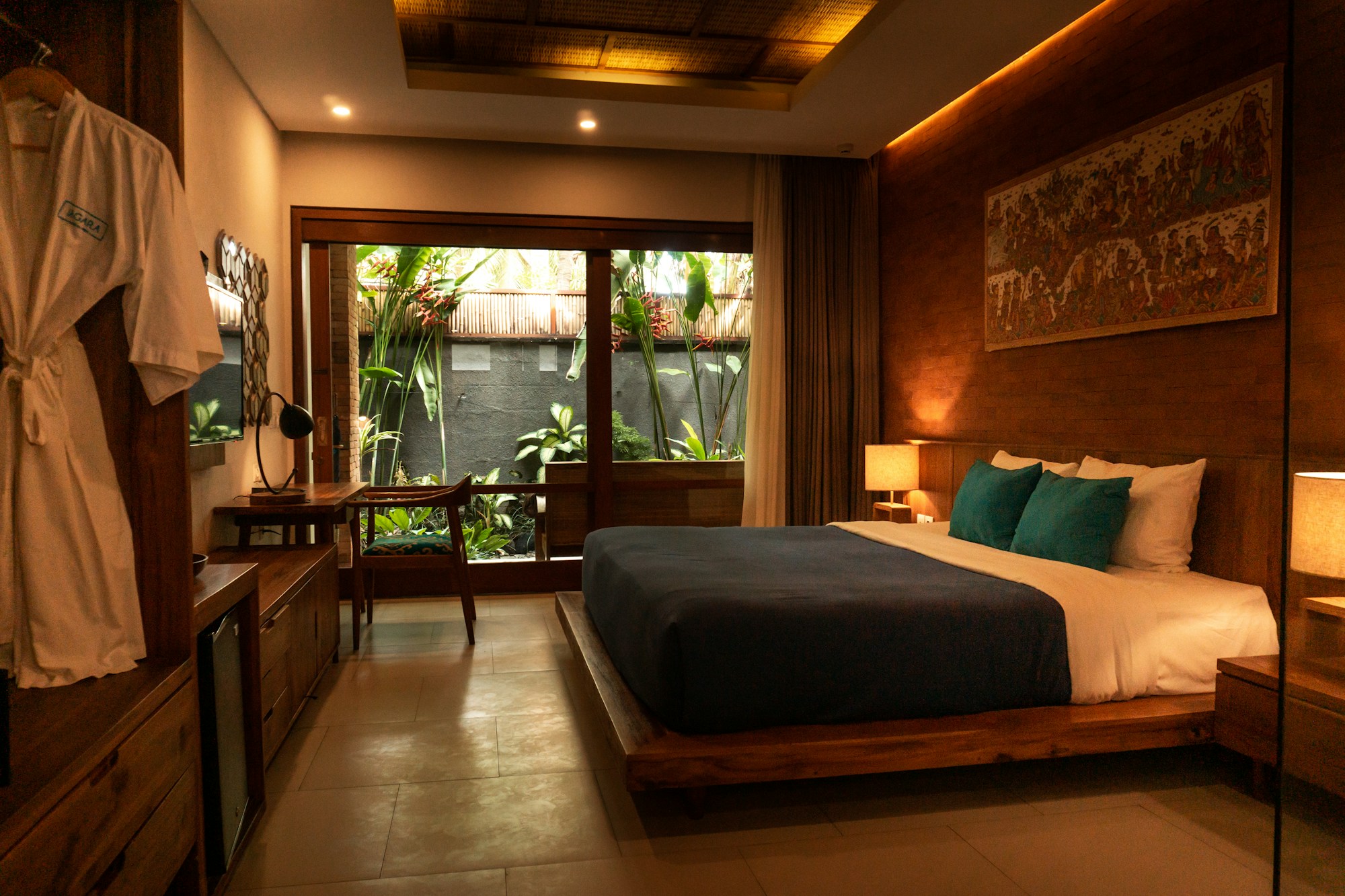 A beautifully layered bed in a warm, tranquil bedroom